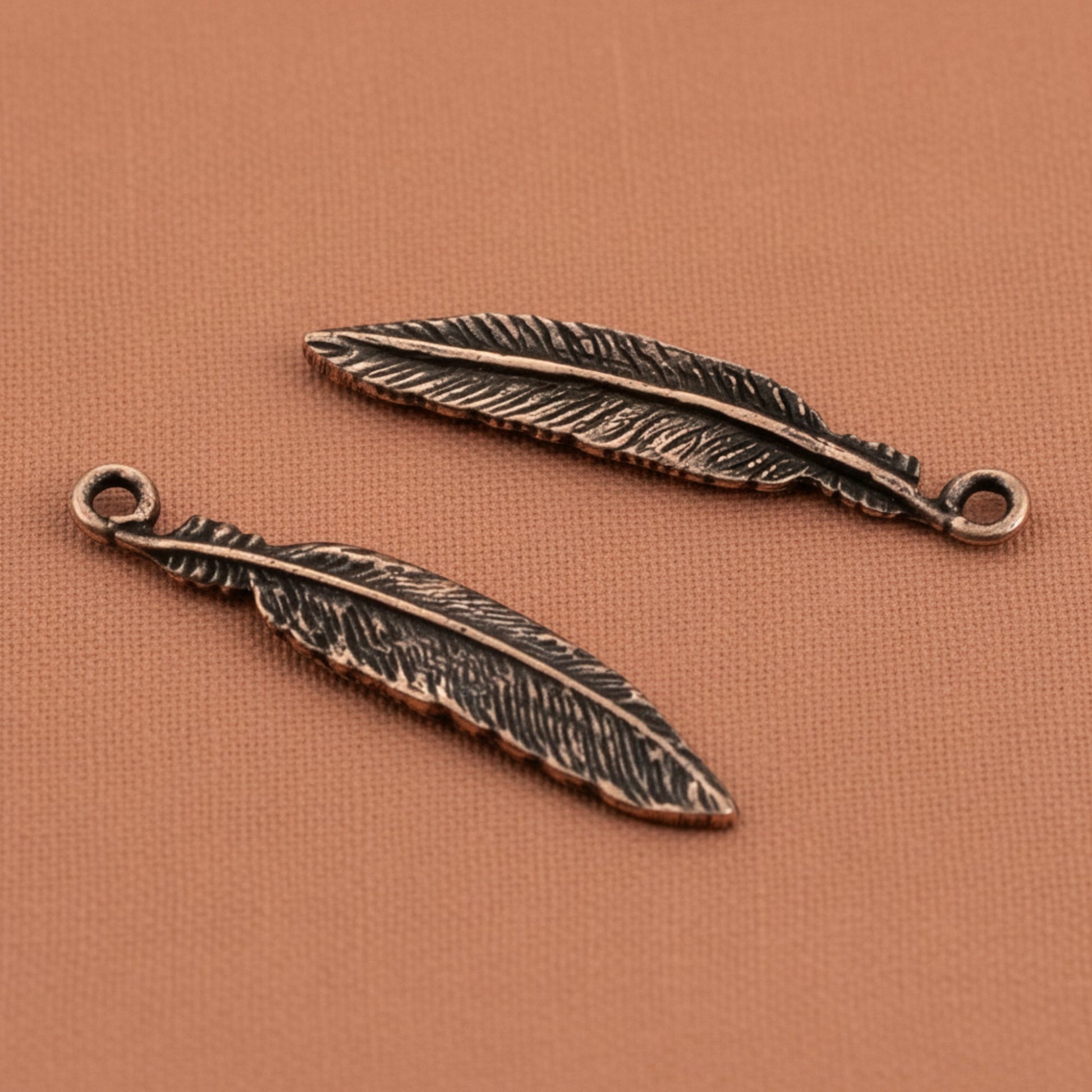 Hackberry Creek antique copper pewter feather charms, 33mm, detailed texture, for boho spiritual nature jewelry.