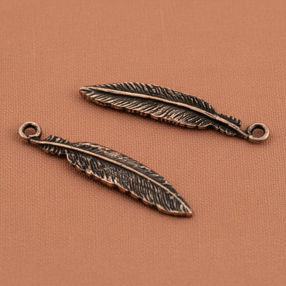 Hackberry Creek antique copper pewter feather charms, 33mm, detailed texture, for boho spiritual nature jewelry.