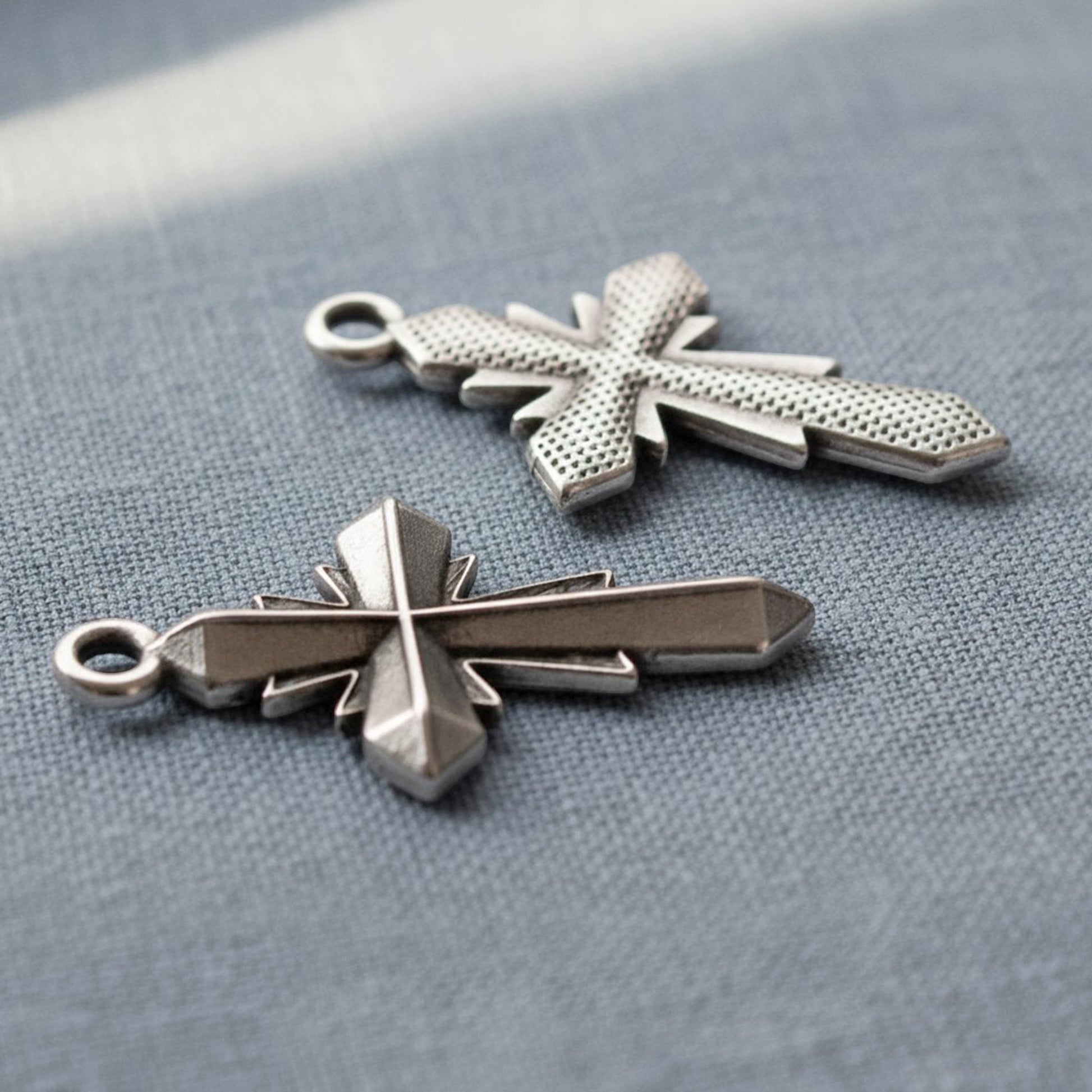 Hackberry Creek silver plated geometric cross pendants with faceted antique finish for artisan jewelry making.