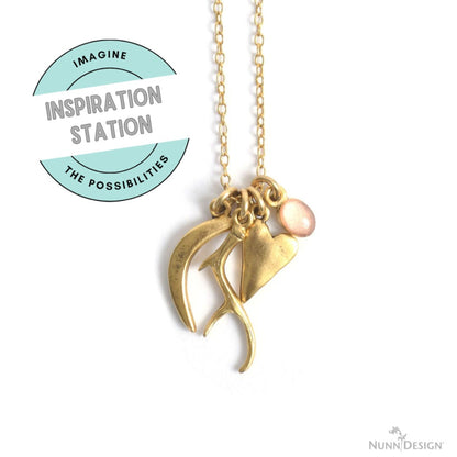 Hackberry Creek gold antler and heart charms on a delicate chain with a pink bead, perfect for artisan jewelry.