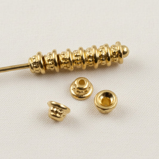 Hackberry Creek 24K gold-plated pewter beaded bead caps with a polished finish for jewelry making.