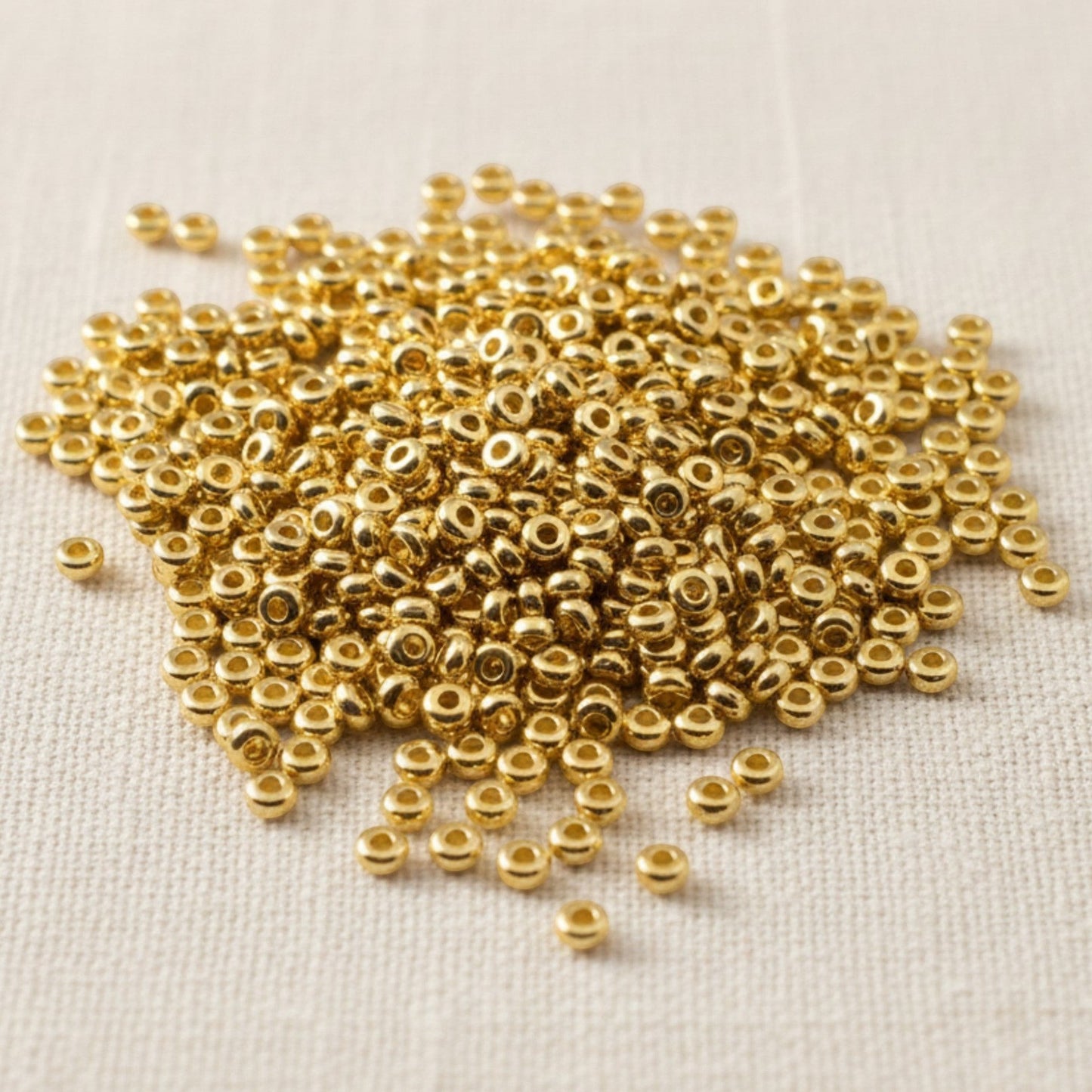 Hackberry Creek 3mm gold 24K-plated pewter heishi spacer beads, 500 pack. Smooth, bright gold finish.