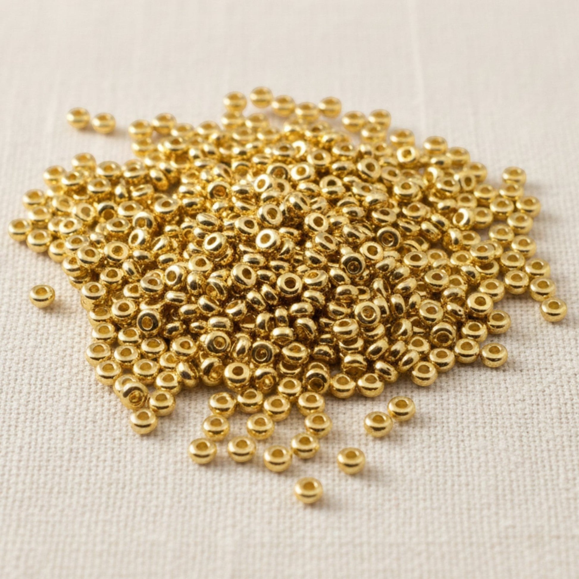 Hackberry Creek 3mm gold 24K-plated pewter heishi spacer beads, 500 pack. Smooth, bright gold finish.