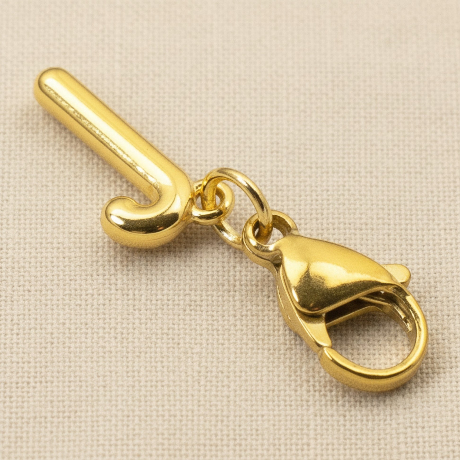 Hackberry Creek gold candy cane clip-on charm with a secure lobster clasp for holiday charm bracelets.