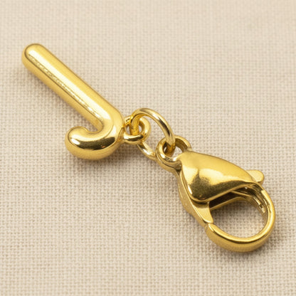 Hackberry Creek gold candy cane clip-on charm with a secure lobster clasp for holiday charm bracelets.