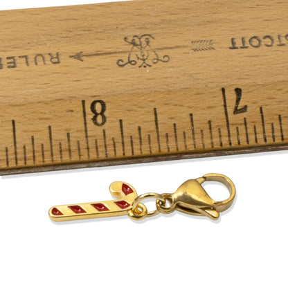 Hackberry Creek 24k gold-plated candy cane charm with red enamel stripes and a secure lobster clasp for jewelry.