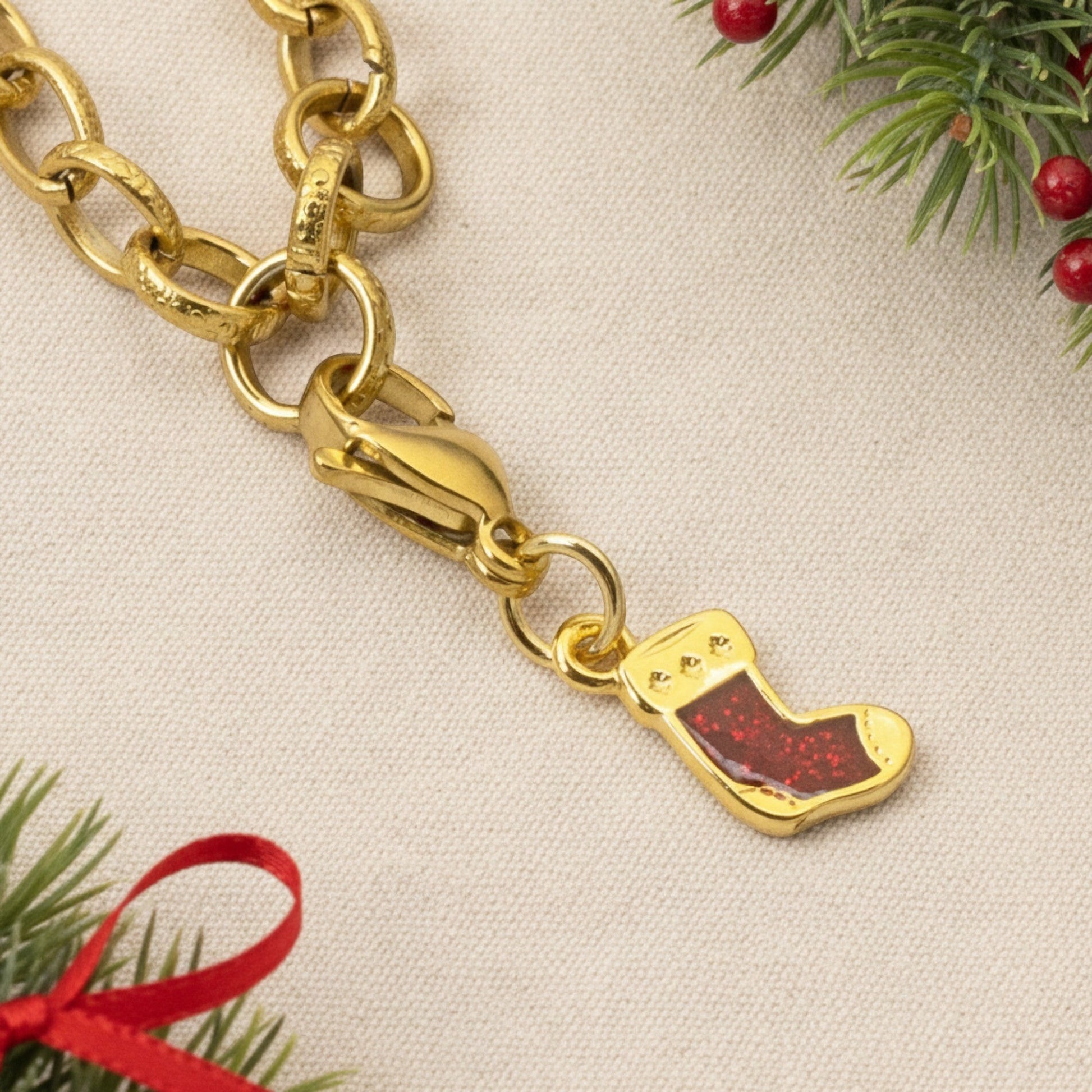 Hackberry Creek gold-plated Christmas stocking charm with red glitter enamel and a secure lobster clasp.