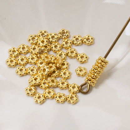 Hackberry Creek 3mm bright gold daisy spacer beads made of pewter with 24K gold plating for jewelry making.