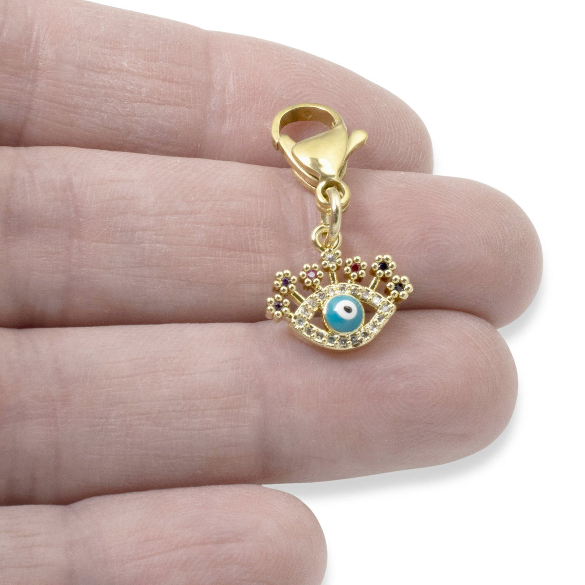 Hackberry Creek gold evil eye charm with blue enamel, clear and multi-colored CZ accents on a lobster clasp