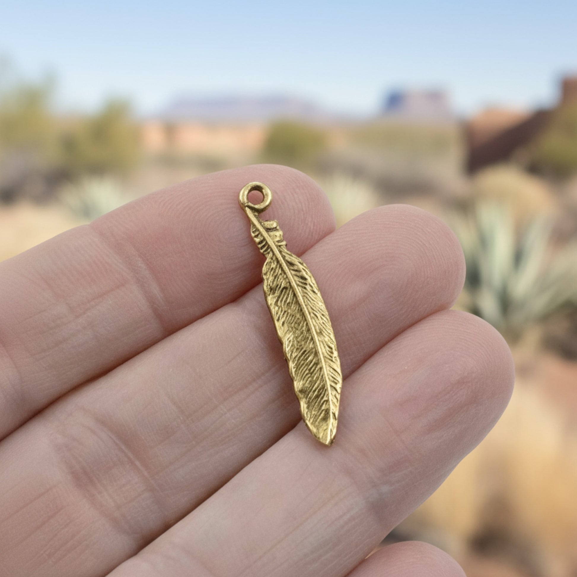 Hackberry Creek gold 24K pewter feather charm, 33mm, detailed texture, boho spiritual nature jewelry.