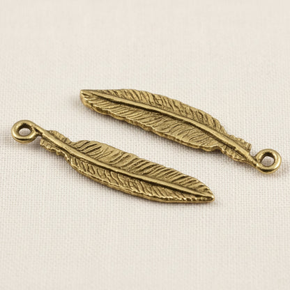 Hackberry Creek two 33mm gold 24K pewter feather charms with intricate detail and a loop for jewelry making.