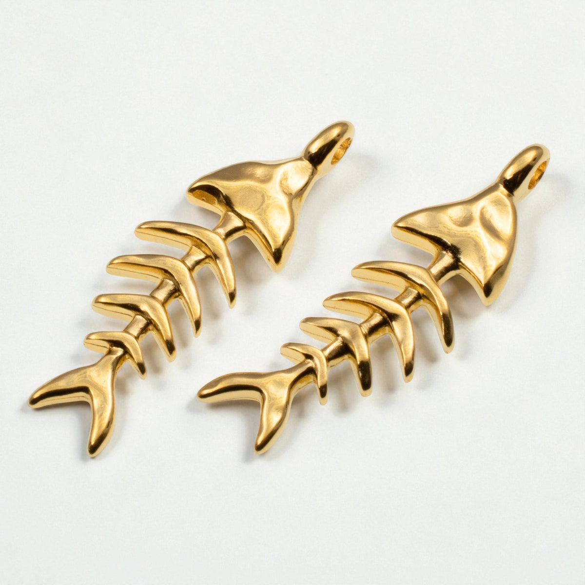 Hackberry Creek 24k gold-plated fishbone skeleton pendants with textured details for coastal jewelry making.