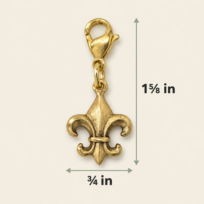 Hackberry Creek 24k gold-plated Fleur de Lis charm with a secure clasp, showing 1 5/8 inch height and 3/4 inch width.