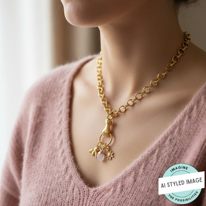 Hackberry Creek gold plated hand holding ring connector pendant with charms on a gold chain necklace.