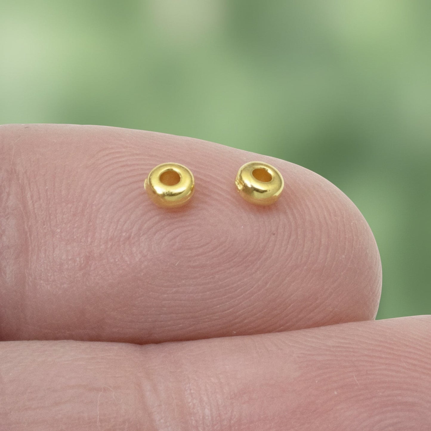 Hackberry Creek 3mm gold-plated pewter heishi spacer beads. Smooth, bright gold finish.