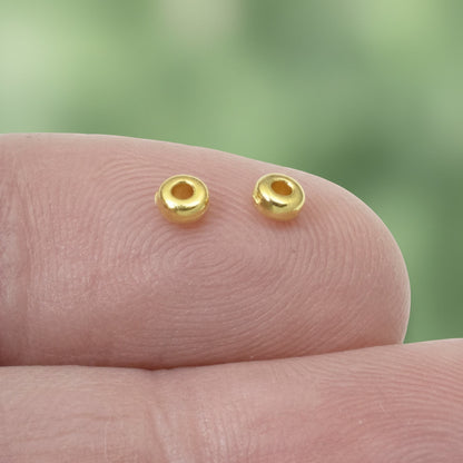 Hackberry Creek 3mm gold-plated pewter heishi spacer beads. Smooth, bright gold finish.