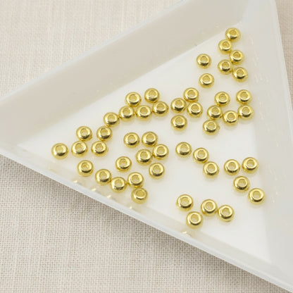 Hackberry Creek 3mm gold heishi disc spacer beads made of 24K-plated pewter. Smooth, bright gold finish.
