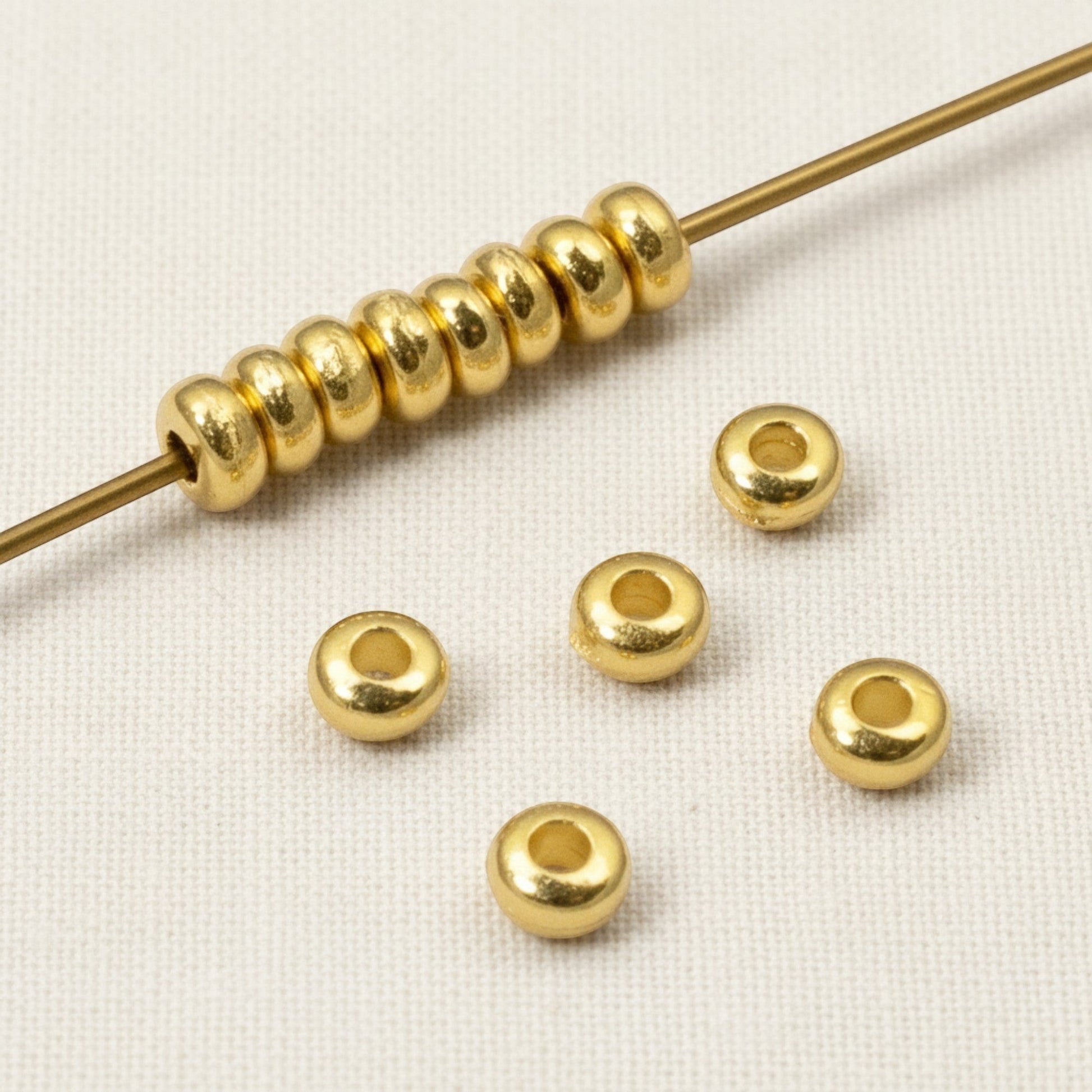 Hackberry Creek 3mm gold heishi disc spacer beads, 24K-plated pewter, smooth finish, jewelry making.
