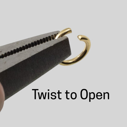 Hackberry Creek 10mm bright gold stainless steel jump ring held by pliers to demonstrate how to twist open.