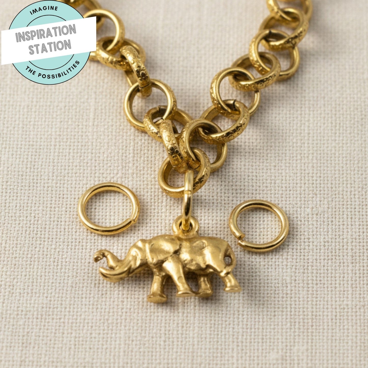 Hackberry Creek 9mm bright gold 304 stainless steel jump rings with an attached gold elephant charm on a chain