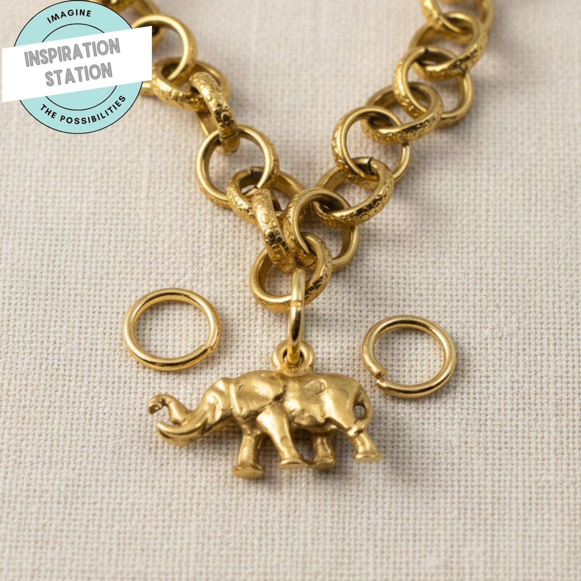 Hackberry Creek 9mm bright gold 304 stainless steel jump rings with an attached gold elephant charm on a chain