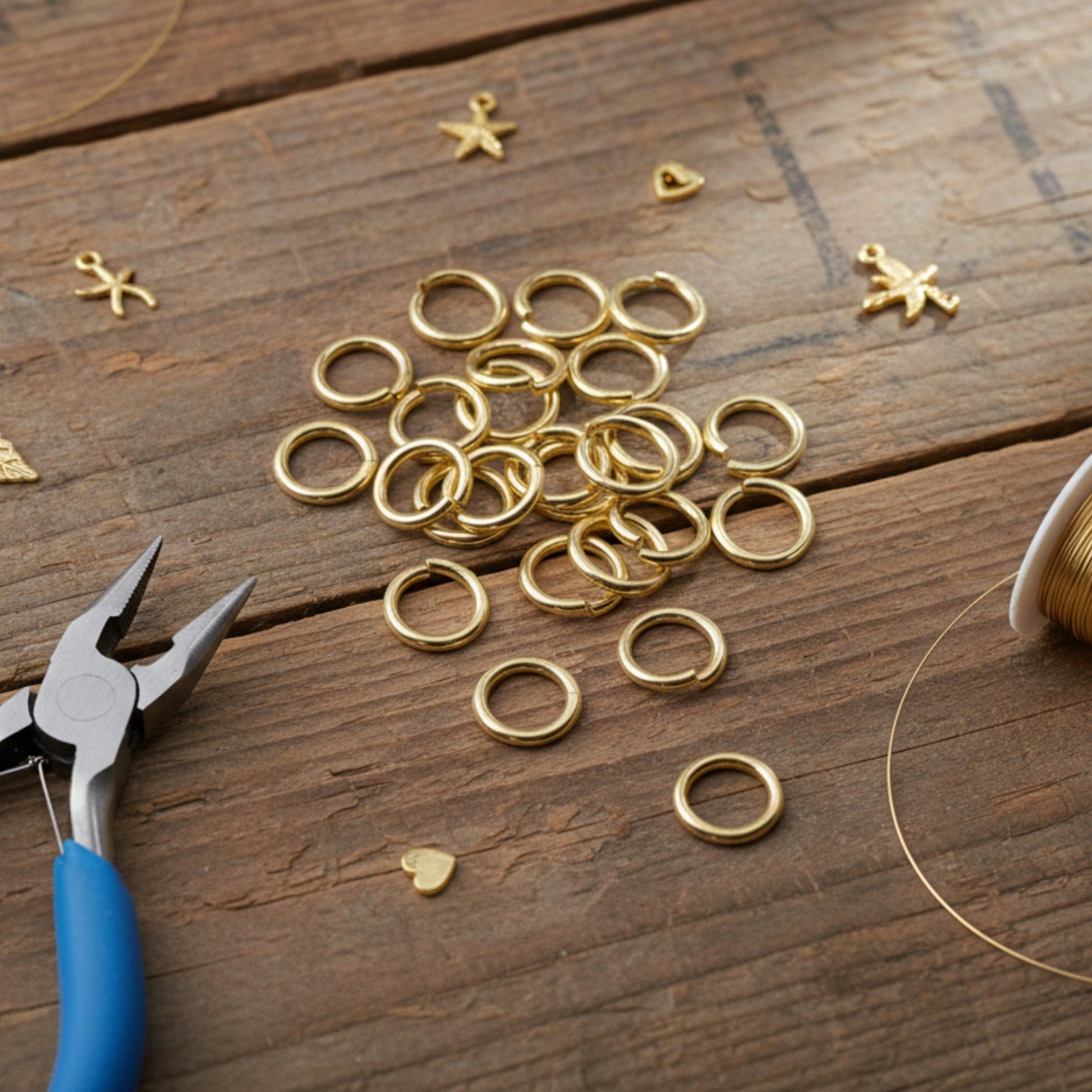 Hackberry Creek 9mm bright gold jump rings made of 304 stainless steel, arranged on a rustic wooden surface.