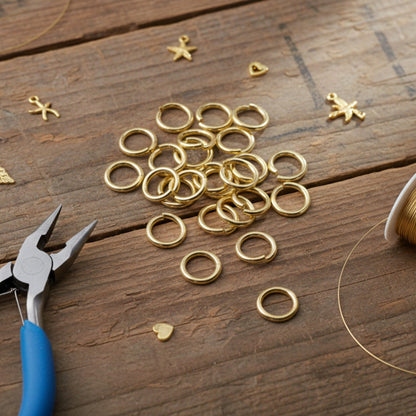 Hackberry Creek 9mm bright gold jump rings made of 304 stainless steel, arranged on a rustic wooden surface.