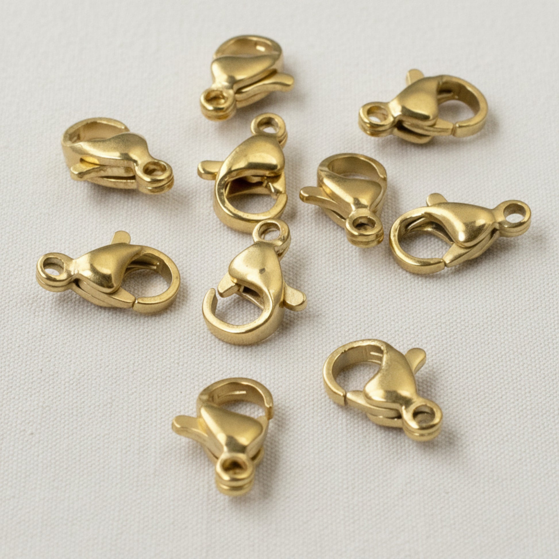 Hackberry Creek set of 10 small 18k gold-plated stainless steel lobster claw clasps for minimalist jewelry making.
