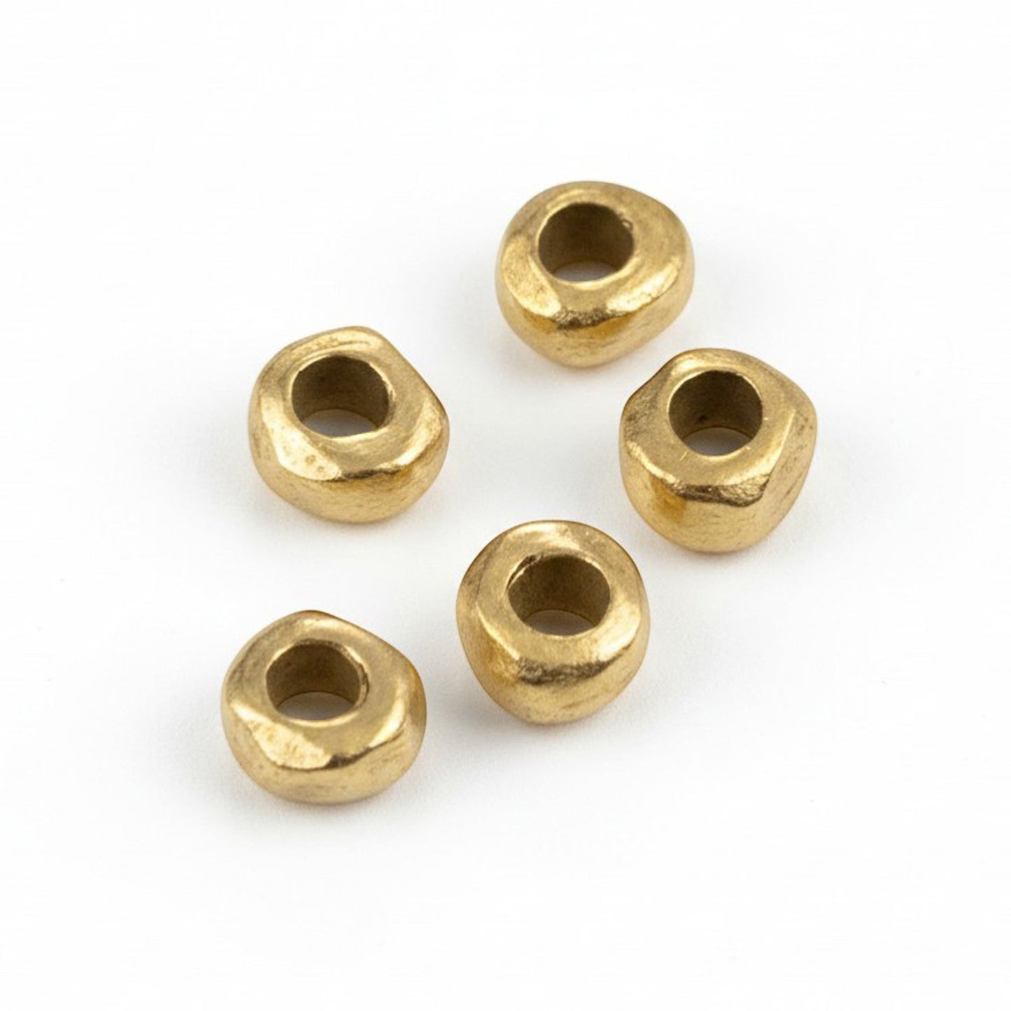Hackberry Creek 24k gold plated pewter nugget spacer beads with an organic, hand-formed shape for jewelry making.