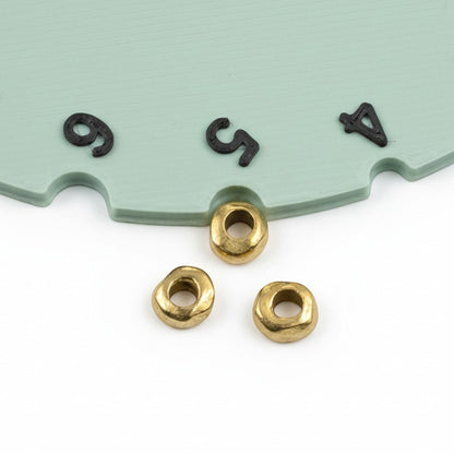 Hackberry Creek 24k gold plated pewter nugget spacer beads with organic rondelle shape for leather cord jewelry.