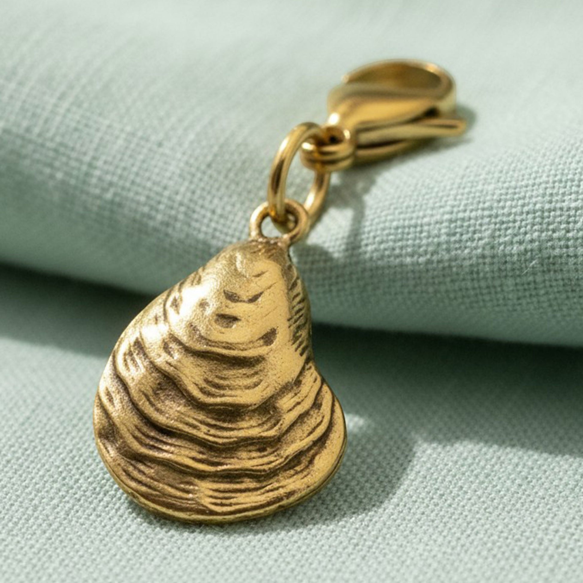 Hackberry Creek 24k gold-plated pewter oyster shell clip-on charm with a stainless steel lobster clasp.