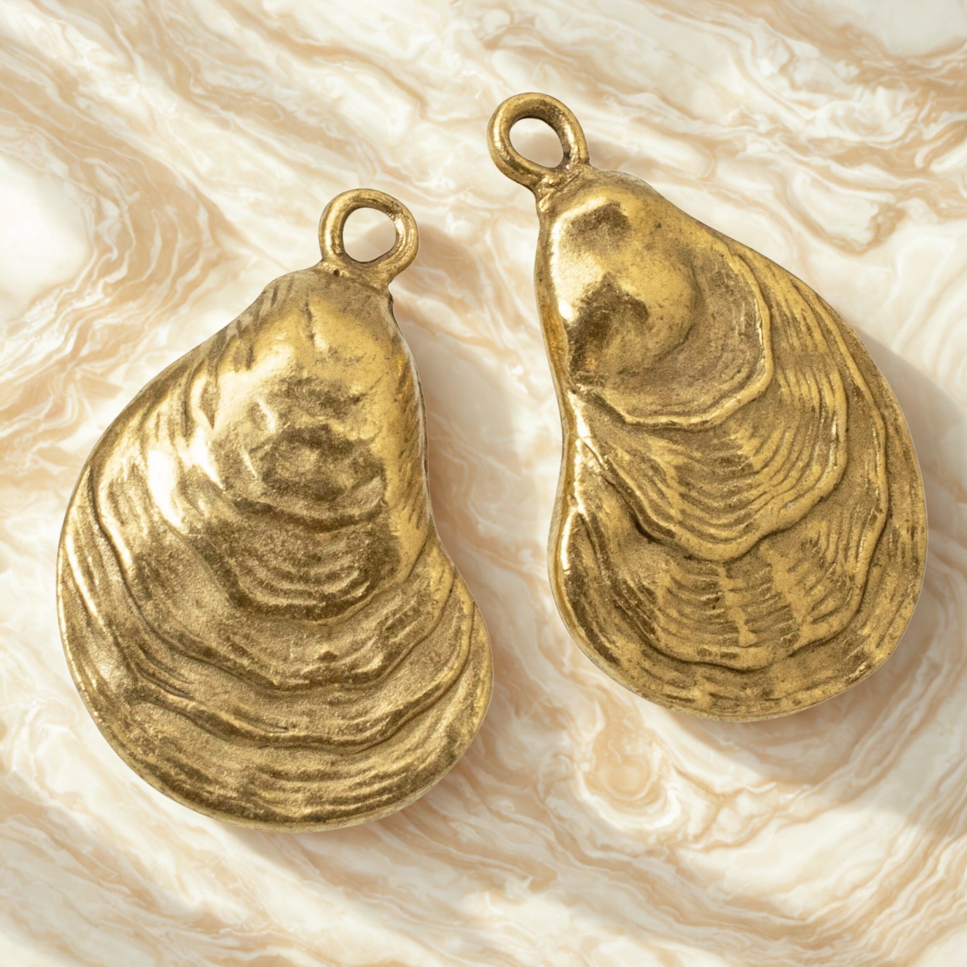 Hackberry Creek 24k gold plated oyster shell charms with antiqued finish for coastal jewelry making.
