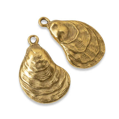 Hackberry Creek set of two 24k gold plated oyster shell charms with an antiqued finish for coastal jewelry making.