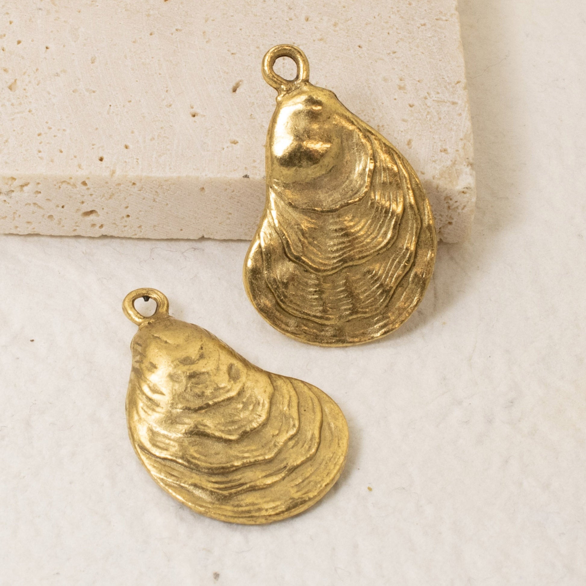 Hackberry Creek set of two 24k gold plated oyster shell charms with an antiqued finish for coastal jewelry making.