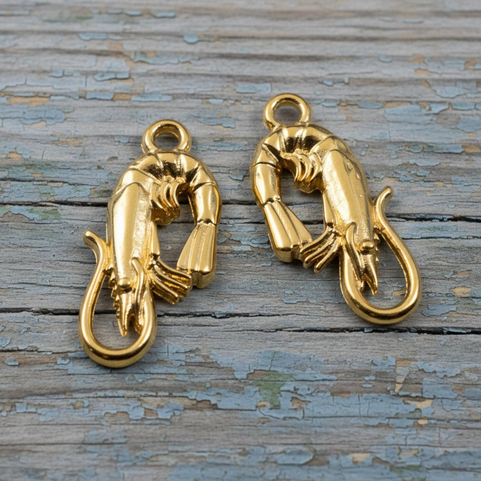 Hackberry Creek two 24K gold plated shrimp charms, detailed and bright finish, for jewelry making.