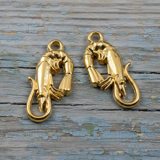 Hackberry Creek two 24K gold plated shrimp charms, detailed and bright finish, for jewelry making.