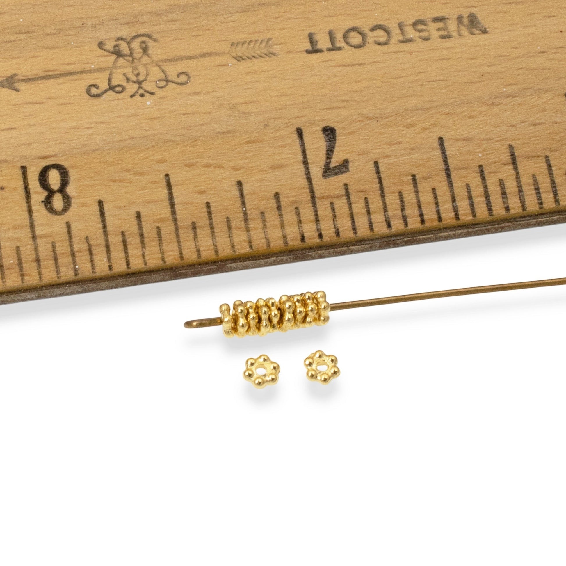 Hackberry Creek 50 bright gold 3mm daisy spacer beads made of lead-free pewter with 24K gold plating.