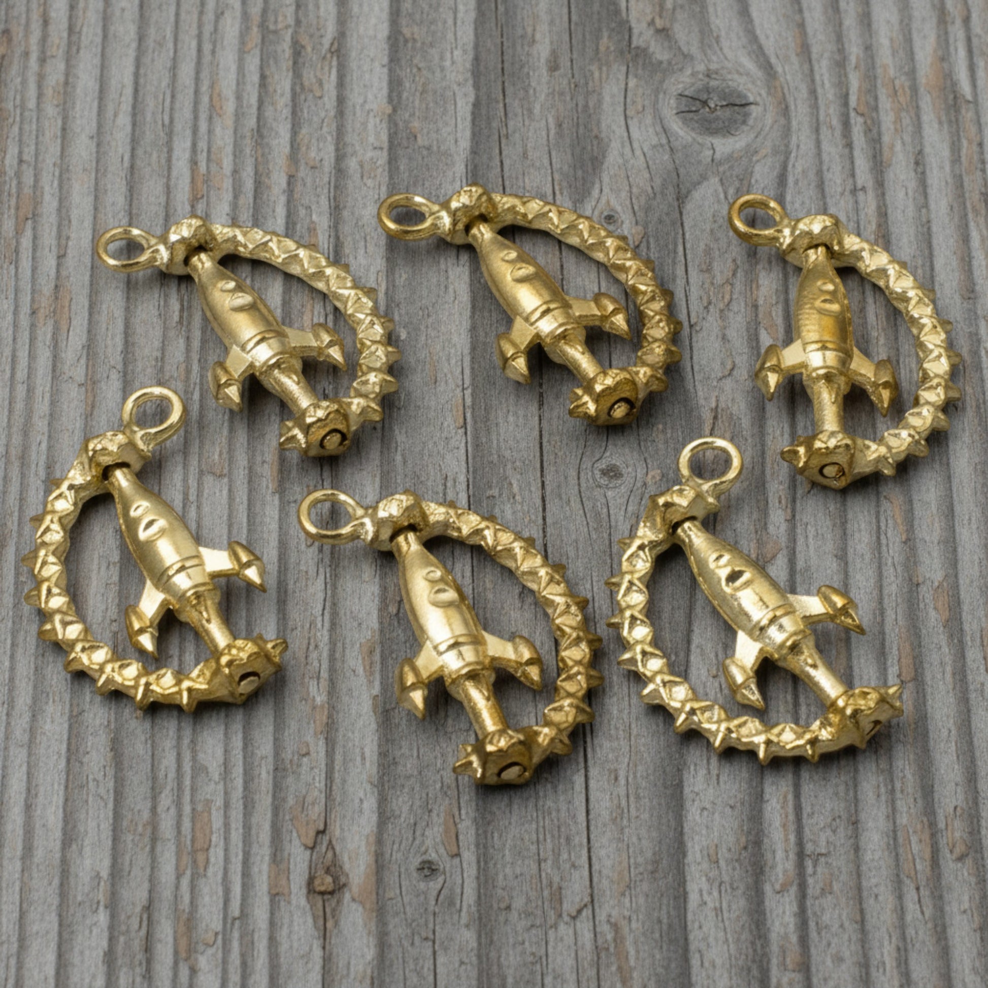 Hackberry Creek gold spinning rocket charms with star details for space-themed jewelry making, 6-pack set