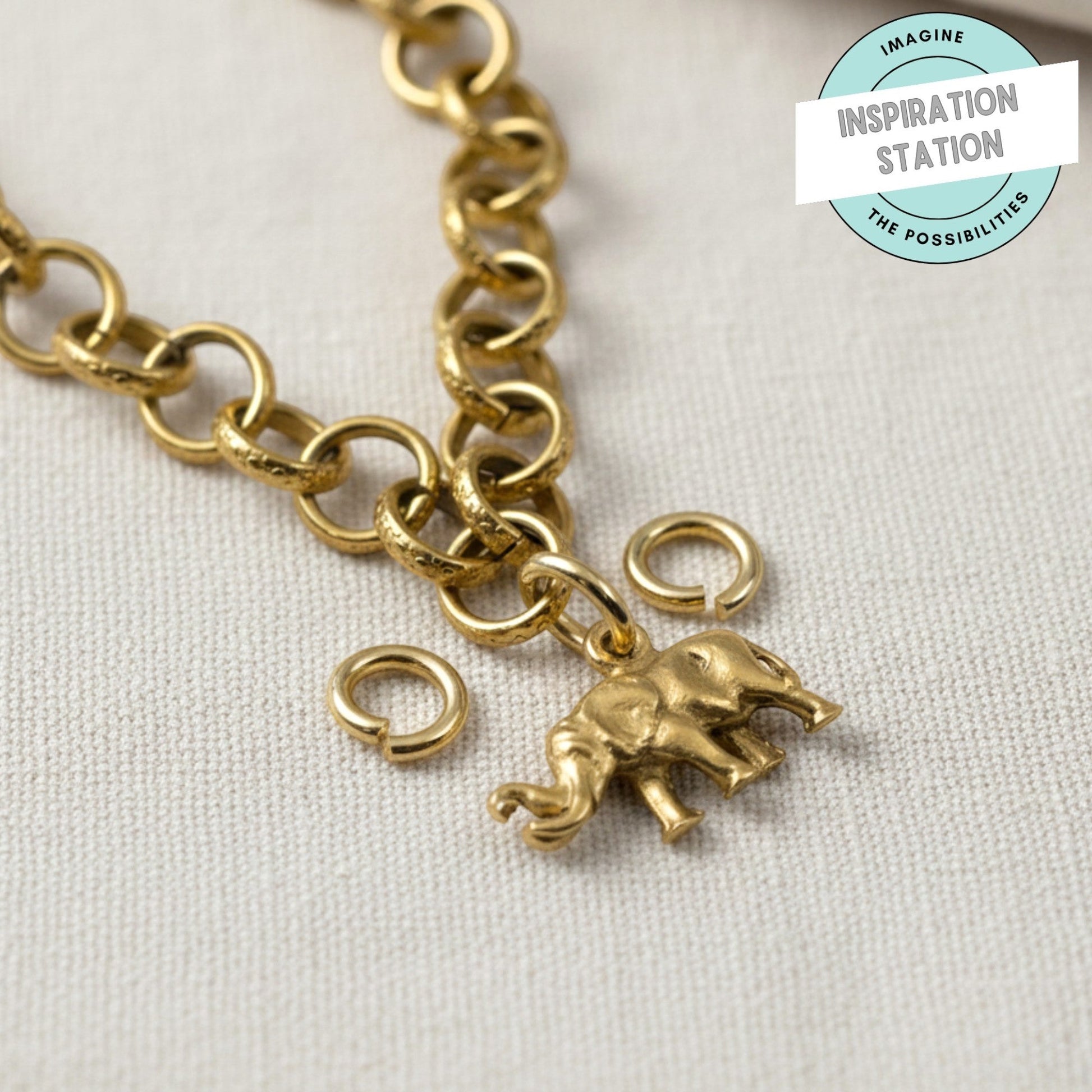 Hackberry Creek 8mm bright gold stainless steel jump rings attached to a textured gold chain with elephant charm
