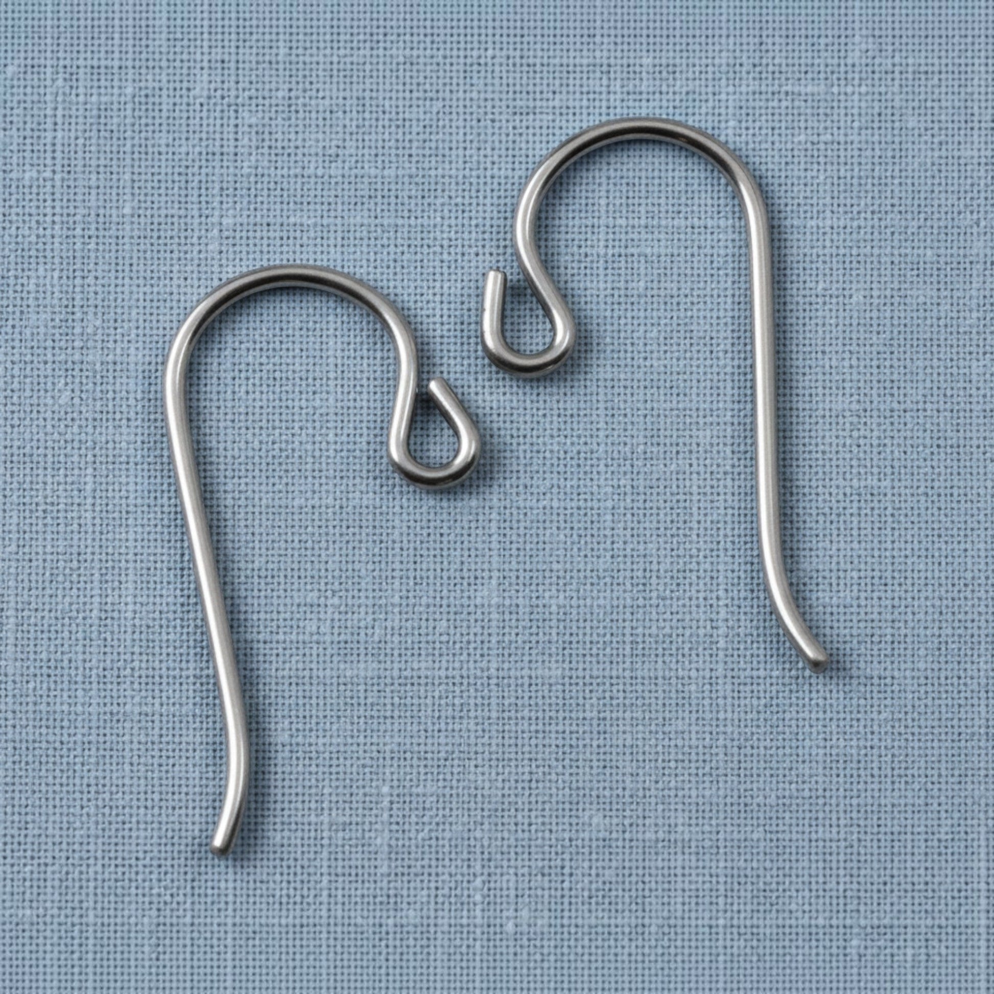 Hackberry Creek hypoallergenic gray niobium French hook ear wires with small loops on a blue fabric background