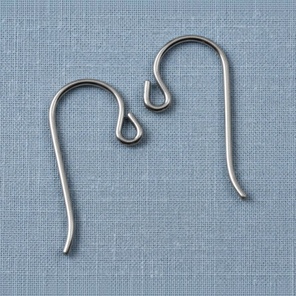Hackberry Creek hypoallergenic gray niobium French hook ear wires with small loops on a blue fabric background