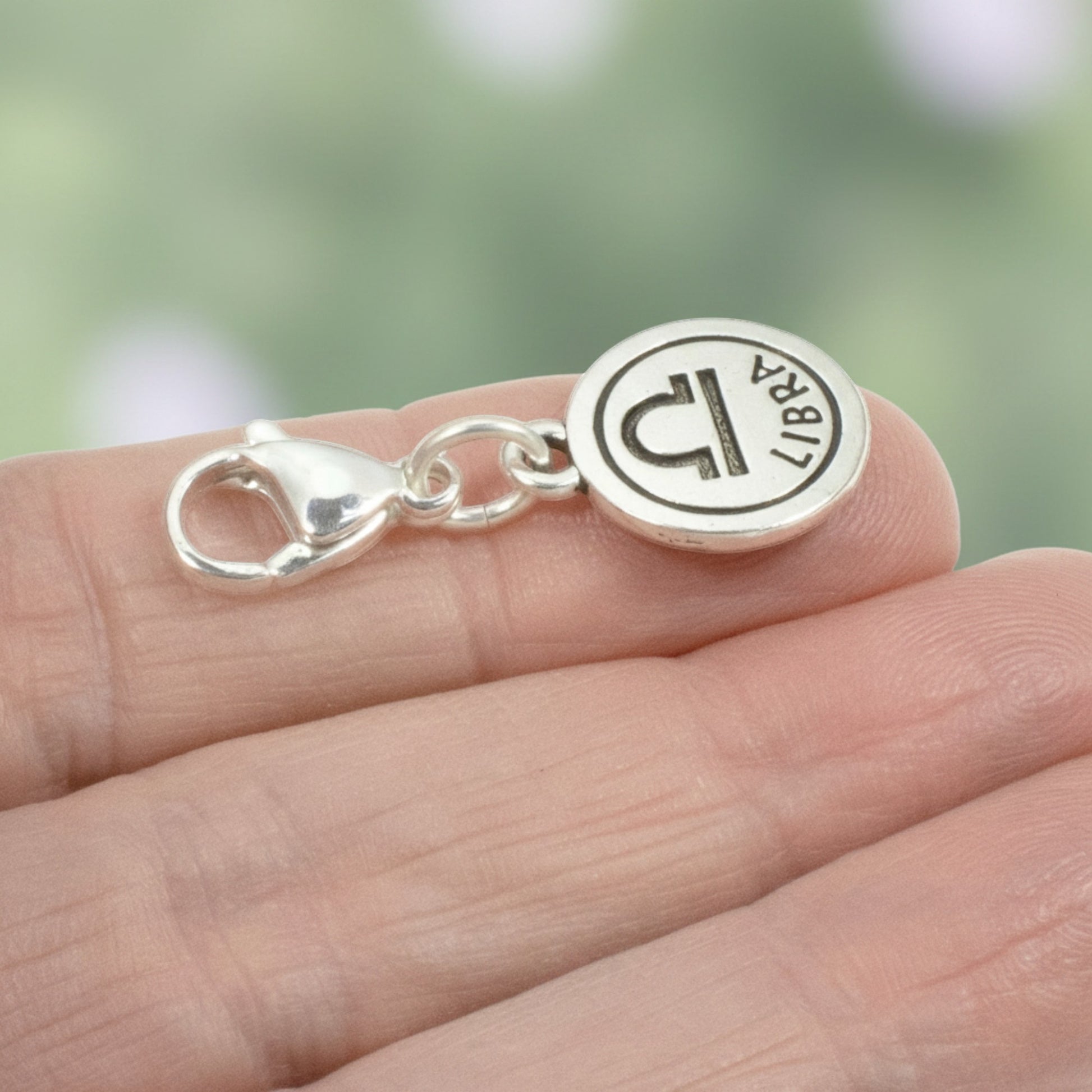 Hackberry Creek silver Libra zodiac charm with lobster clasp featuring the scales symbol on a round pewter pendant.