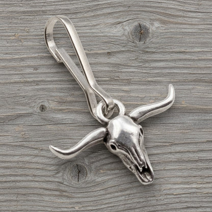 Hackberry Creek silver-plated pewter longhorn steer skull zipper charm with stainless steel clasp on wood background