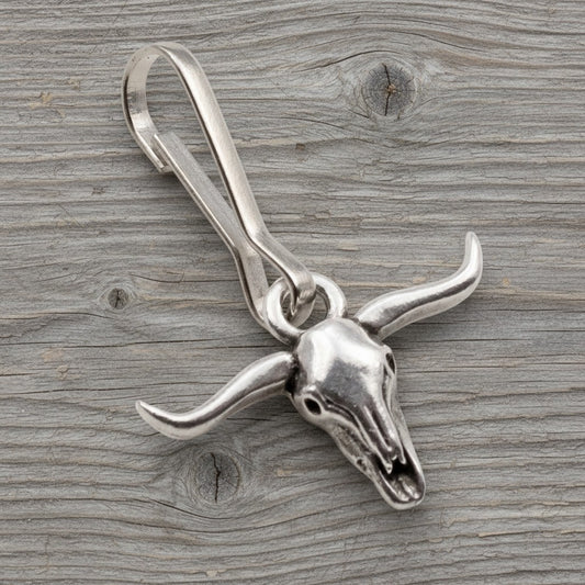 Hackberry Creek silver-plated pewter longhorn steer skull zipper charm with stainless steel clasp on wood background