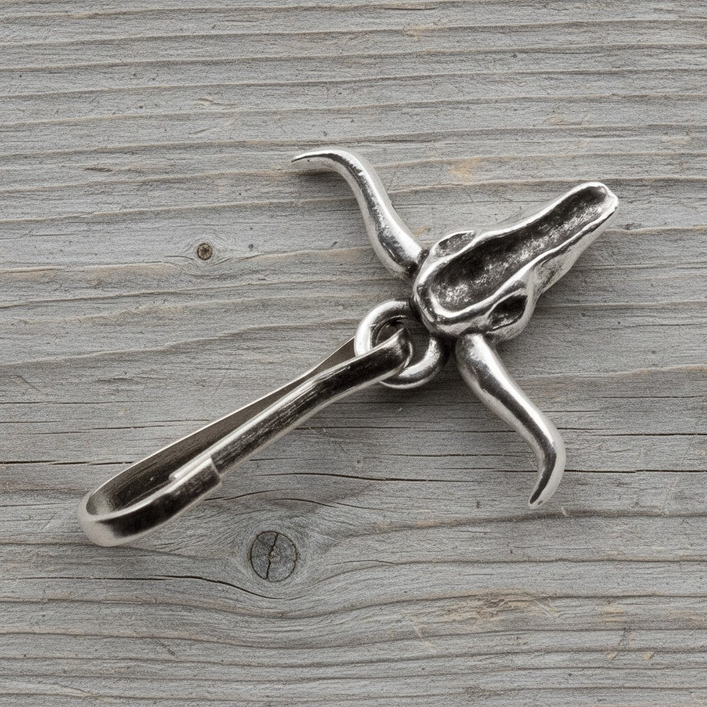 Hackberry Creek pewter longhorn steer skull zipper charm with antiqued silver finish on a rustic wood background.
