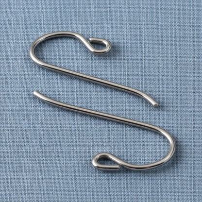 Hackberry Creek hypoallergenic gray niobium French hook ear wires with small loops on a blue fabric background.