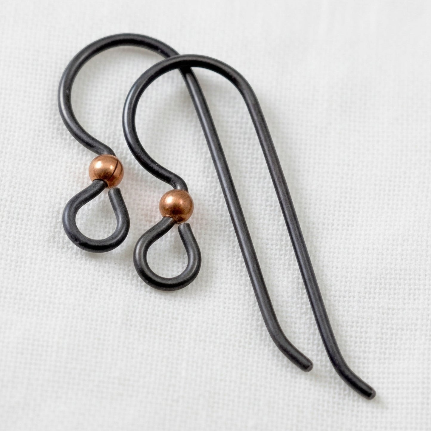 Hackberry Creek matte black niobium earring hooks with copper bead, 20 gauge, hypoallergenic for sensitive ears.