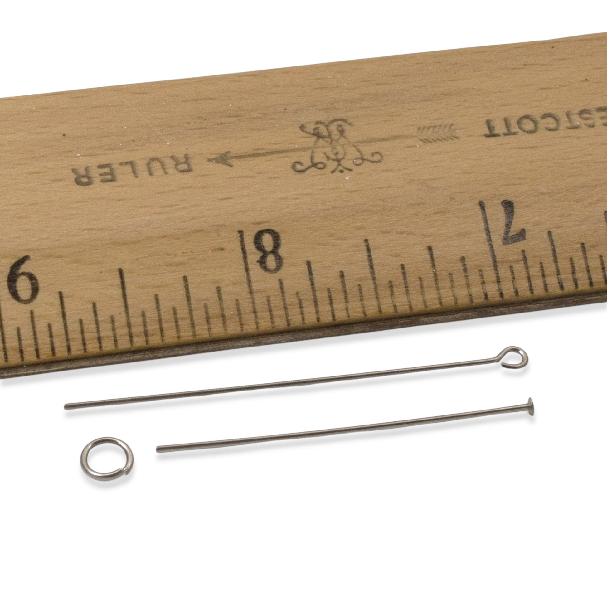 Hackberry Creek gray niobium earring kit findings: 2 ear wires, 1 head pin, 1 eye pin, and 1 jump ring shown with a ruler.