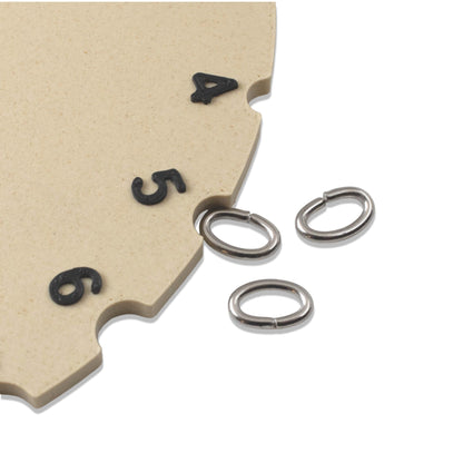 Hackberry Creek 8x5mm dark silver 304 stainless steel oval jump rings next to a sizing gauge tool