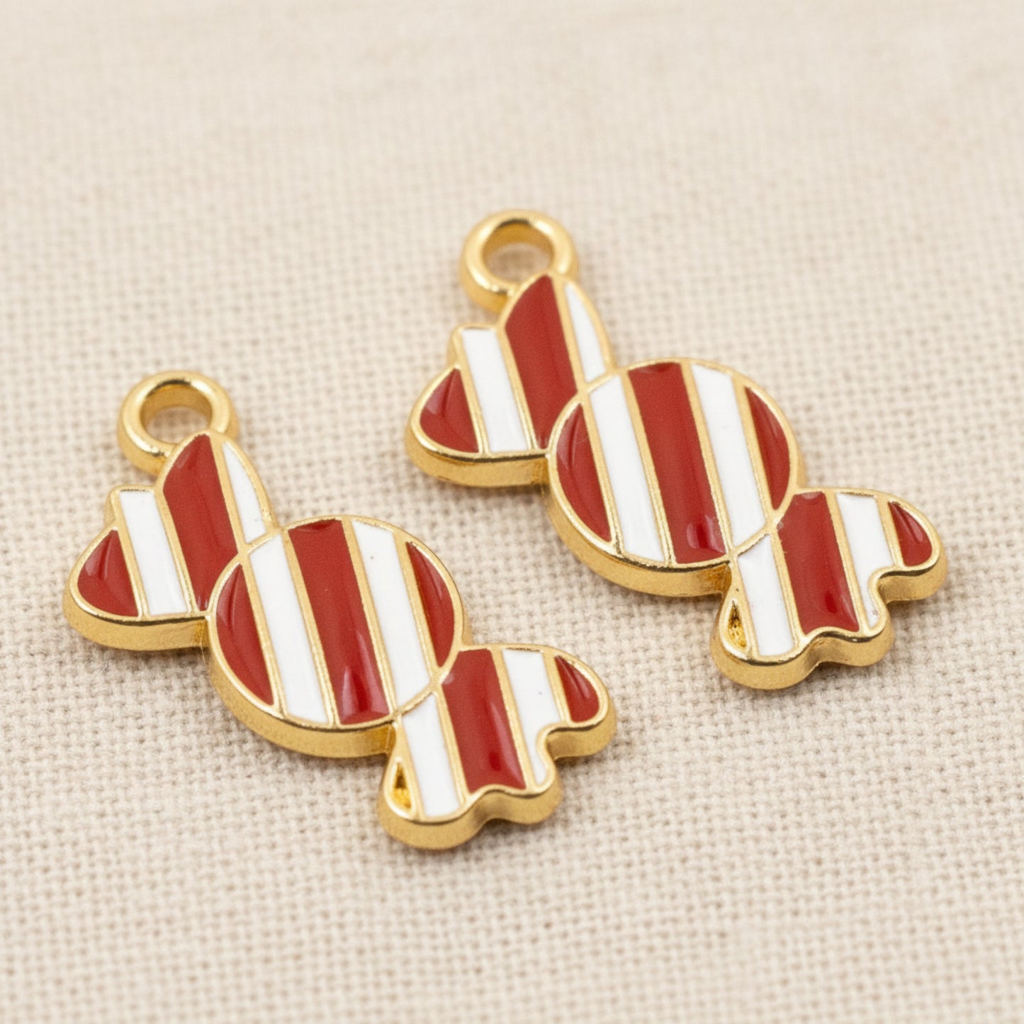 Hackberry Creek peppermint candy charms with red and white striped enamel and gold-plated metal for holiday crafts.